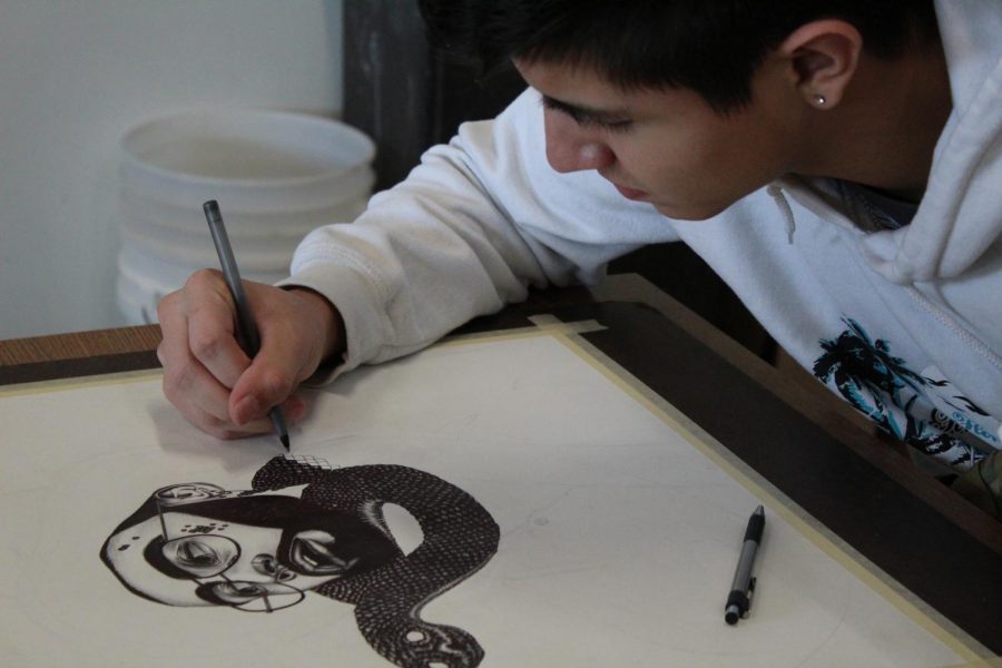 Robert Fuentes working on his drawing.