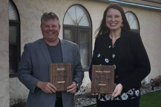 Jim Kasik and Michelle Burton receive the Region 3 Principal of the Year award.