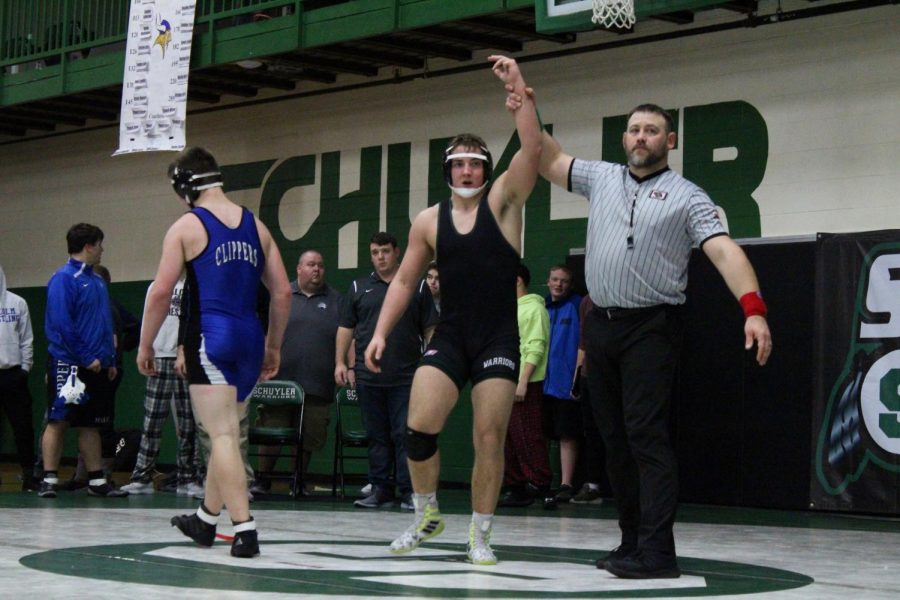 Travis Marxsen gets his hand raised after winning.