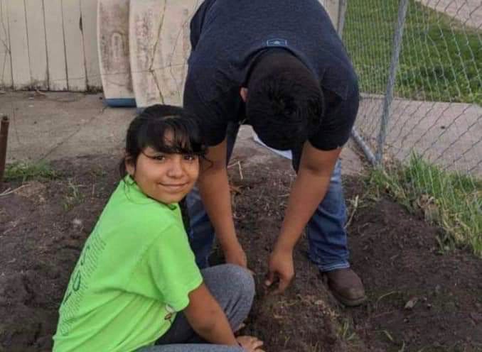 Bryan and Yareli Romero help plant trees with the SCS Warriors Academy program.