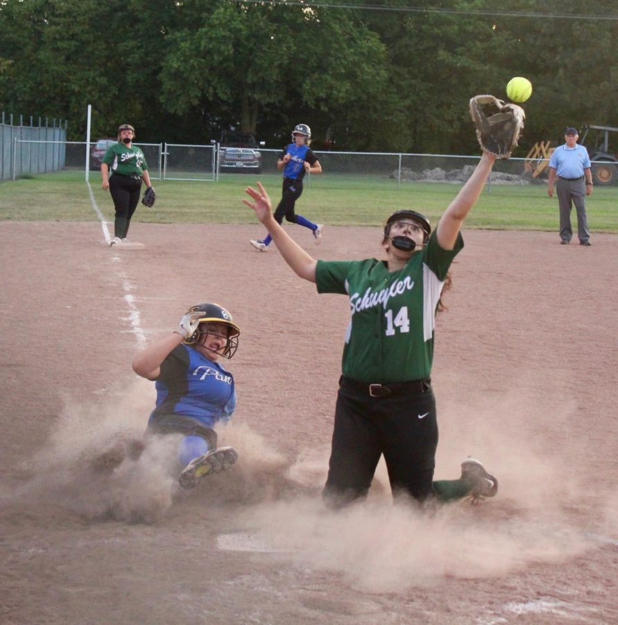 Pitcher, Lucy Mendez, fights time to get runner out.
