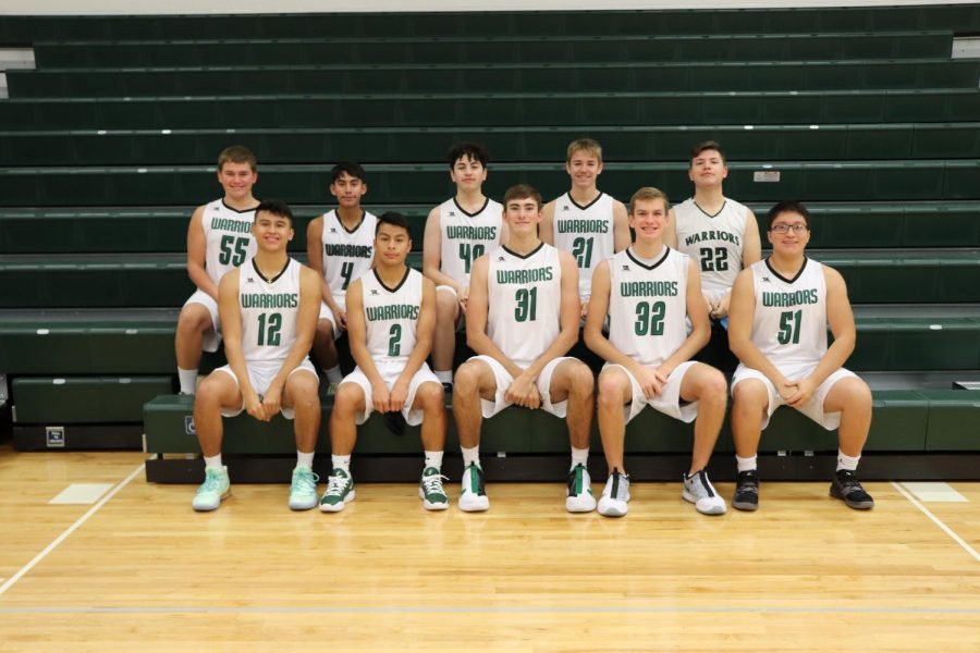 SCHS Boys Basketball team poses for picture on the bleachers.
