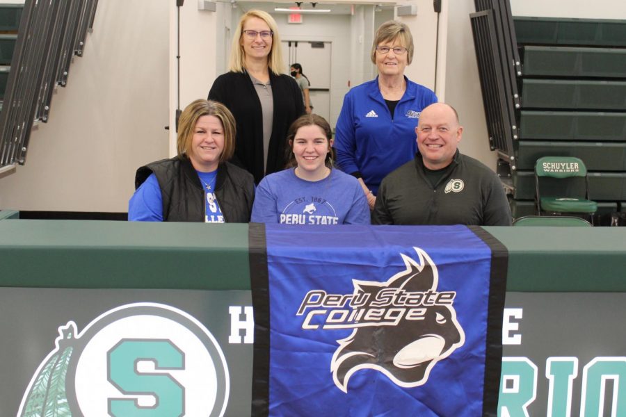 Carly Johnson and parents pose for picture with her high school golf coach, Shanda Hall and Peru State College coach.