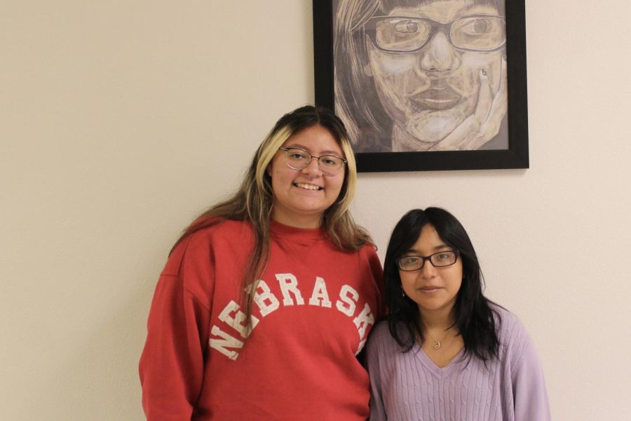 Aivlis Serrato and Yessica Garcia  standing in front of Yessicas portrait. Not Pictured was Emily Daviu.