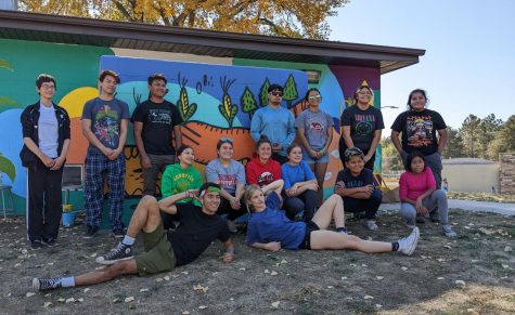 Volunteers pose as they finish the mural for the day.