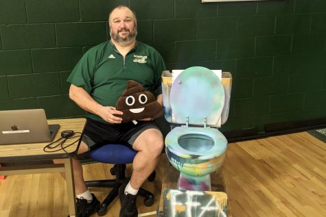 Mr. Hlavac posing with toilet used in the Toilet Transfer during FFA Week.