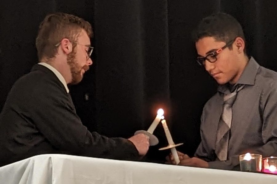 Omar Gonzalez is being inducted as a new member by NHS President Ben Lefdal.