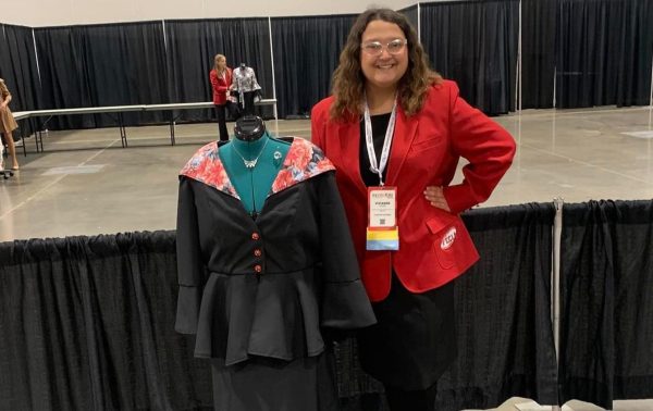 Vivi Anne posing with the outfit she designed for Nationals.