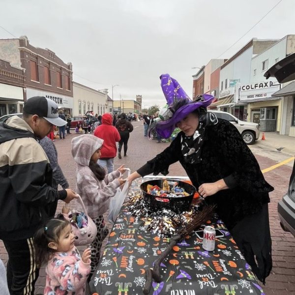 A Schuyler business hands candy to the trick or treator. 
