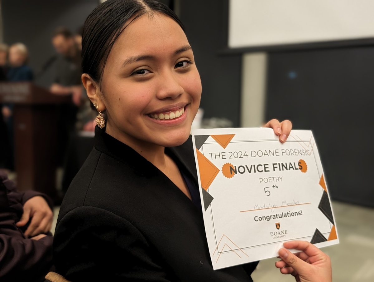 Madalyn Mendez smiles as she holds her certificate for 5th place in Novice Poetry.