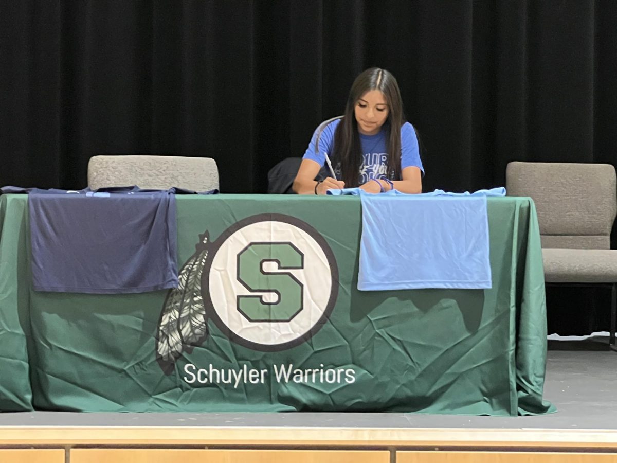 Maribel Gonzalez signing her letter of intent to play ball at Southeast Community College.
